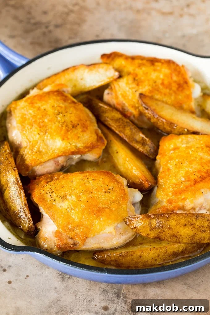 Chicken thighs, potatoes, broth, and seasonings are ready to be combined in a pan for Chicken Vesuvio.