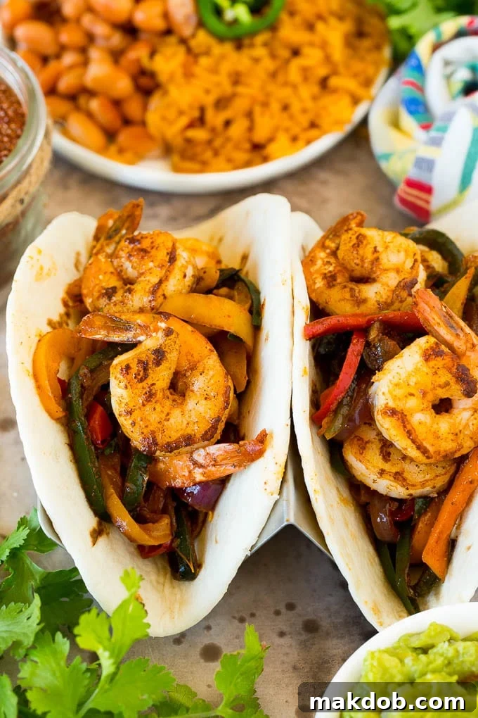 A vibrant platter of sizzling chicken fajitas, garnished with fresh cilantro and lime wedges, ready to be served.