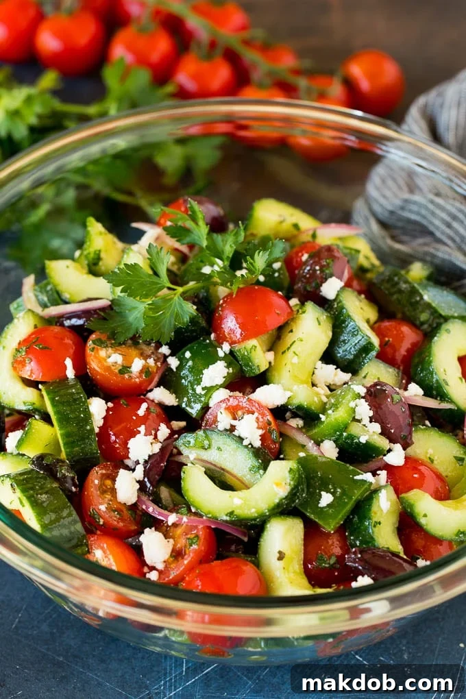 Fresh Mediterranean Salad 2 A bowl of Mediterranean salad with tomatoes, cucumbers, peppers and olives, garnished with feta.