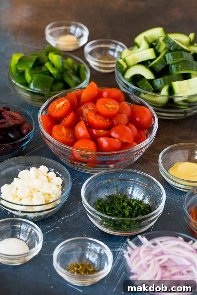 Fresh Mediterranean Salad 3 Bowls of vegetables, feta cheese and salad dressing ingredients, ready for assembly.
