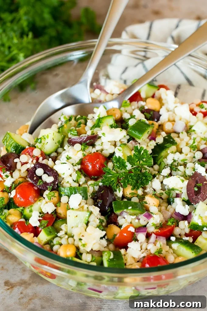 Vibrant Mediterranean Couscous Salad 2 A bowl of couscous salad garnished with parsley.
