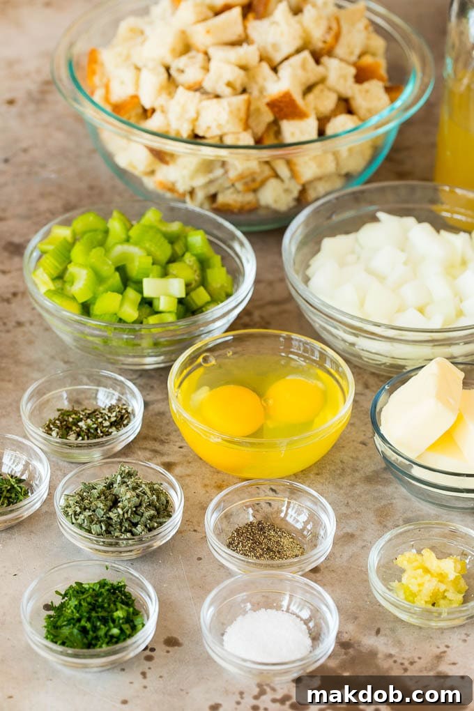 Bowls of perfectly cubed rustic bread, freshly chopped vegetables, and a vibrant assortment of fresh herbs, ready for mixing.