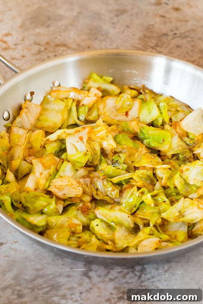 This cabbage and sausage skillet is a combination of smoked sausage, vegetables and savory seasonings, all cooked together to make a quick and easy dinner. Sauteed cabbage with seasonings in a skillet.