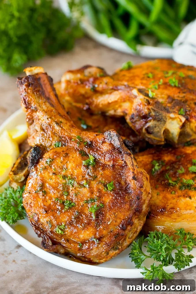 A plate of air fryer pork chops garnished with parsley.
