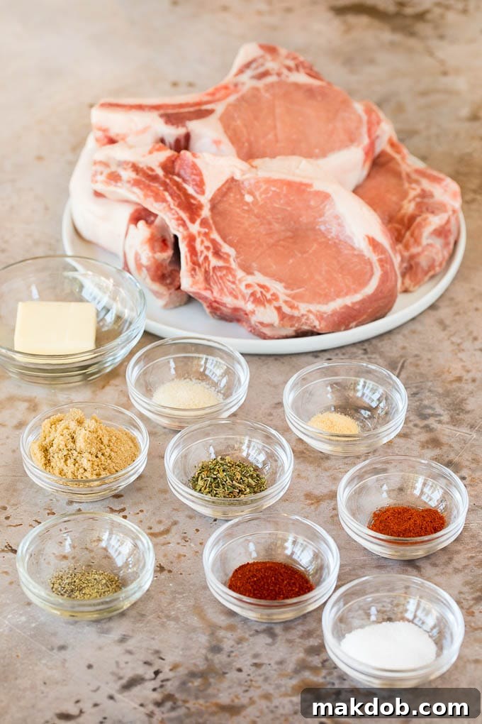 Pork chops on a plate with bowls of herbs and spices.
