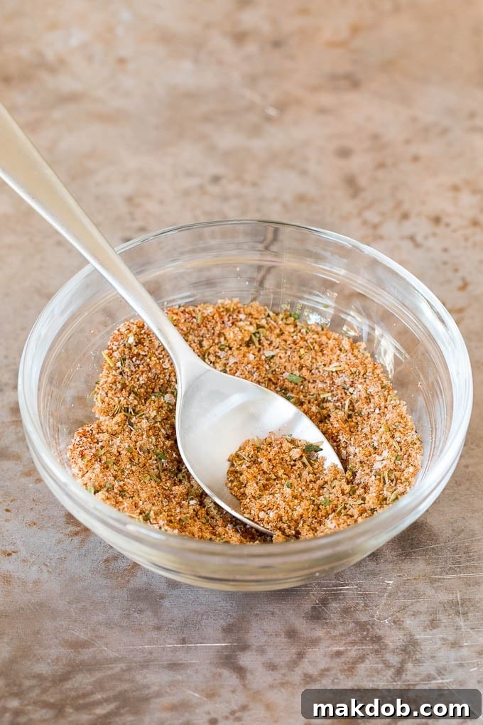 A spice mix in a bowl with a spoon.