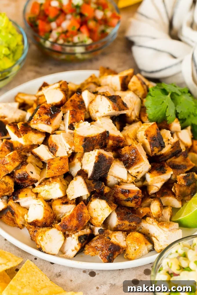 Chopped Chipotle chicken on a plate served with salsas.