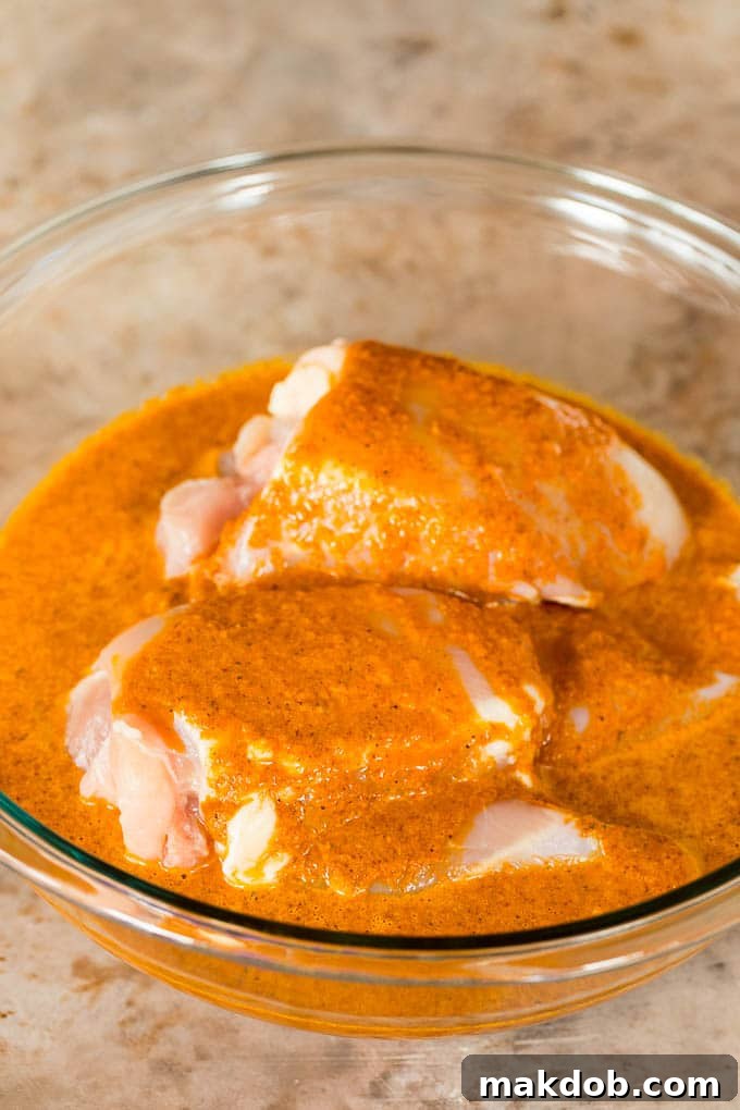 A bowl of chicken in a marinade.