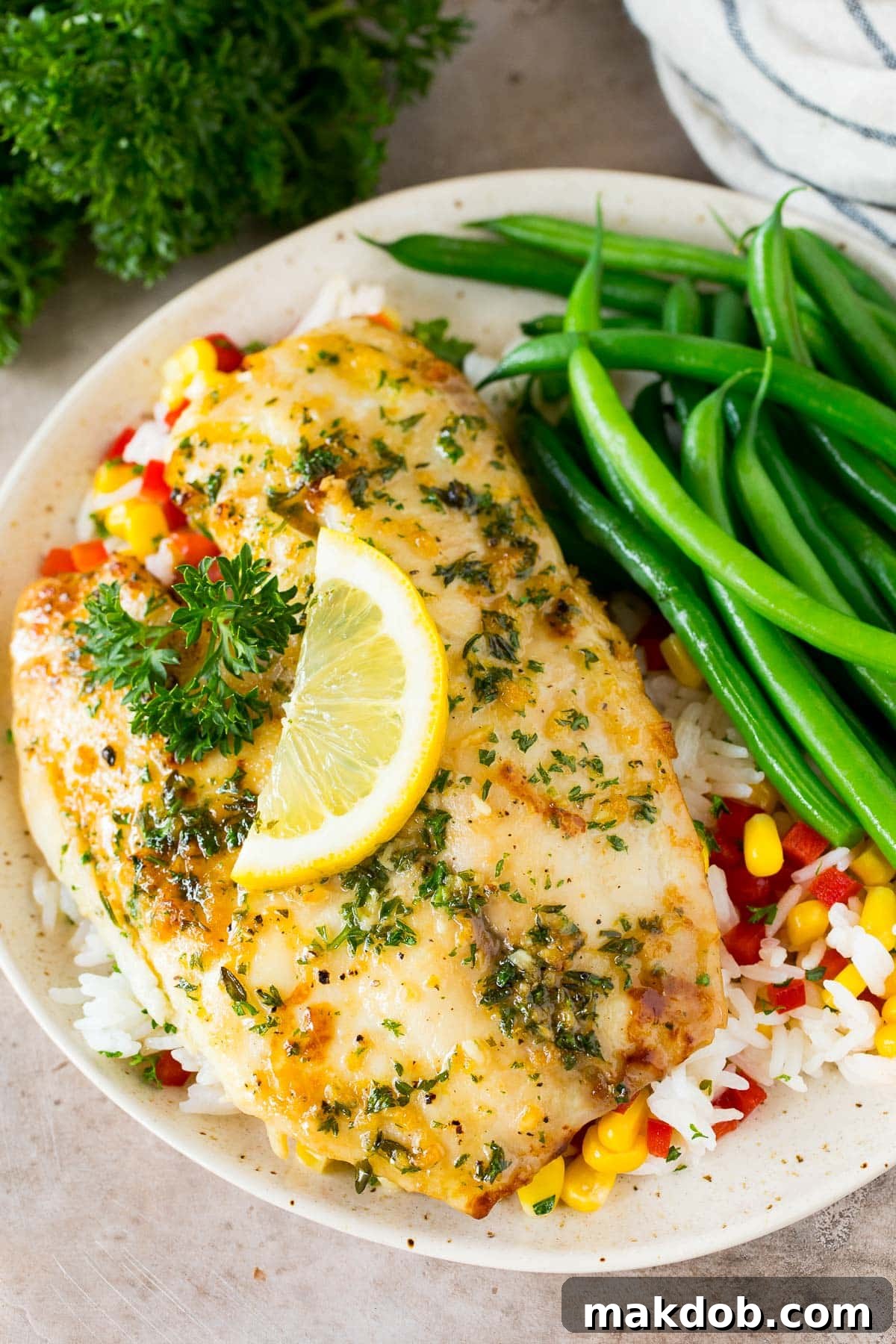 Savory Garlic Butter Tilapia Bake 6 Baked tilapia served with rice and green beans.