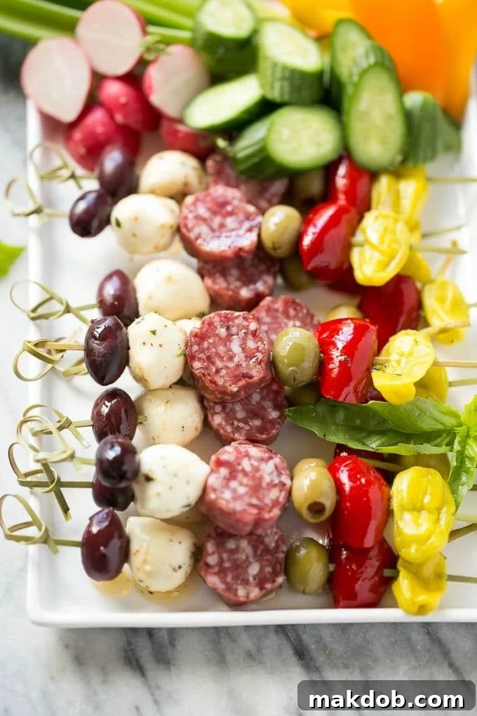 Antipasto Skewers Recipe | Easy Antipasto | Best Antipasto #antipasto #skewers #appetizer #dinneratthezoo A beautifully arranged tray of colorful antipasto kabobs featuring a variety of Italian meats, briny olives, and fresh vegetables, ready for serving.