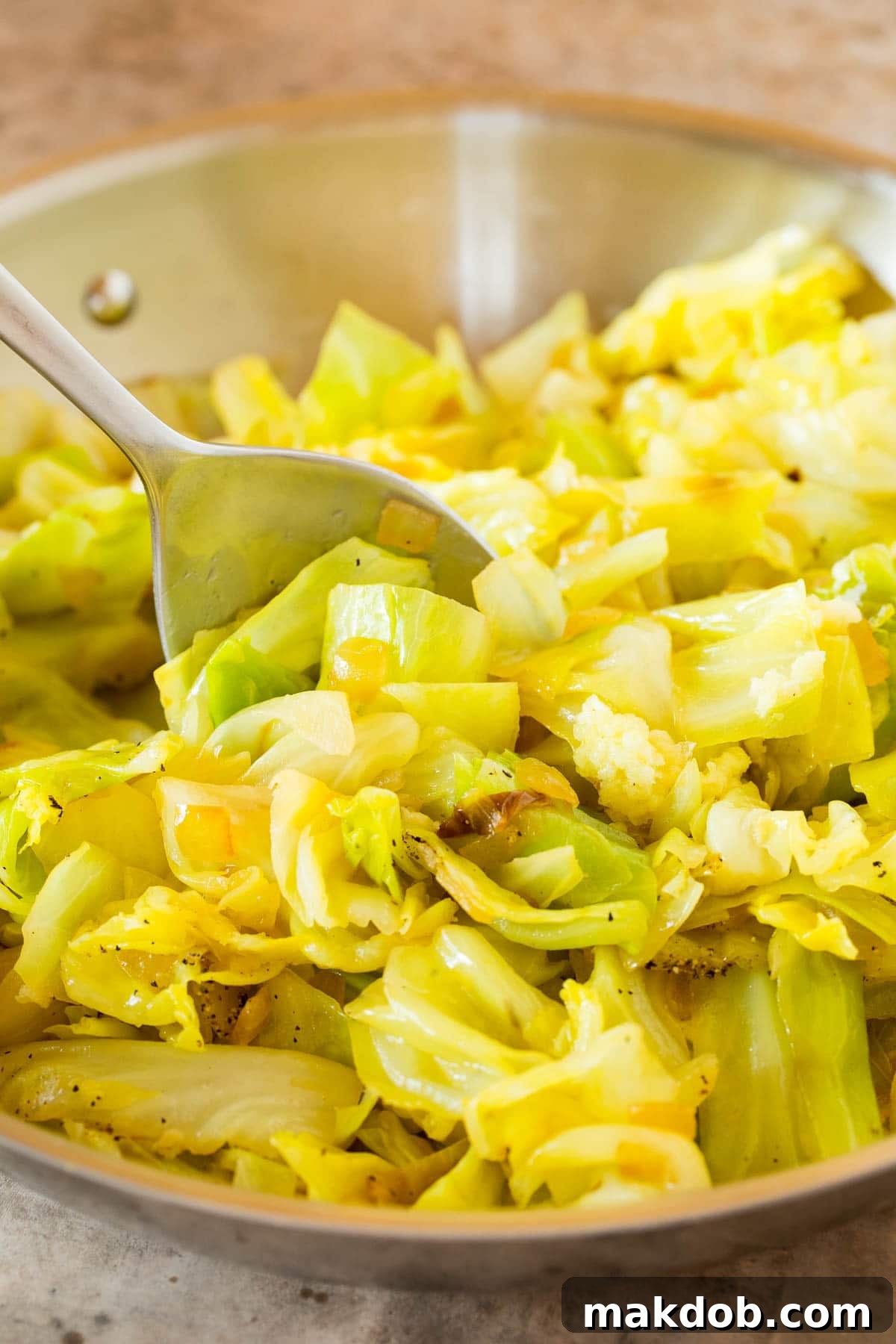 A pan filled with perfectly cooked, tender sauteed cabbage, ready to be served.