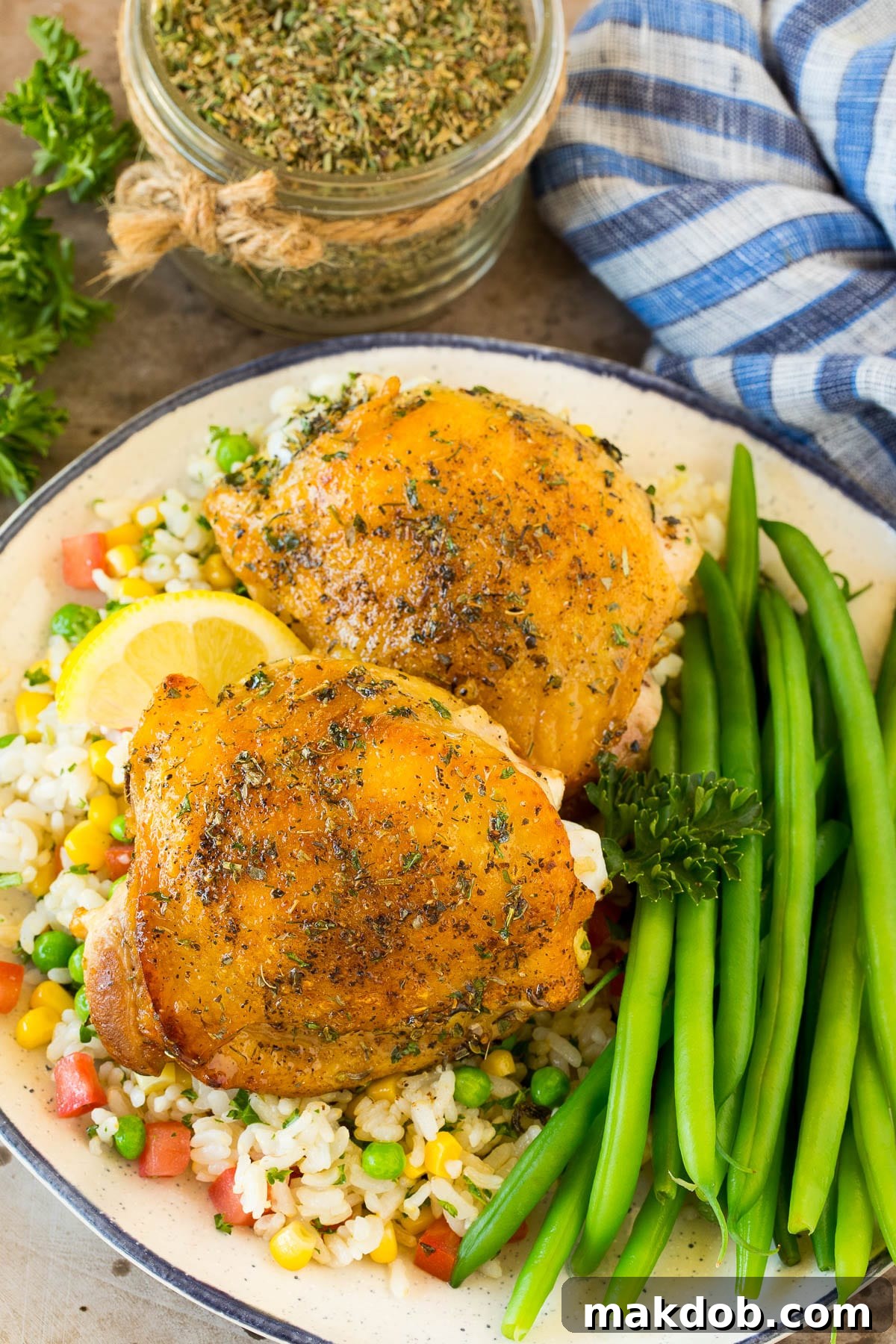 Chicken cooked with Greek seasoning served alongside rice and green beans, showcasing a delicious meal idea.