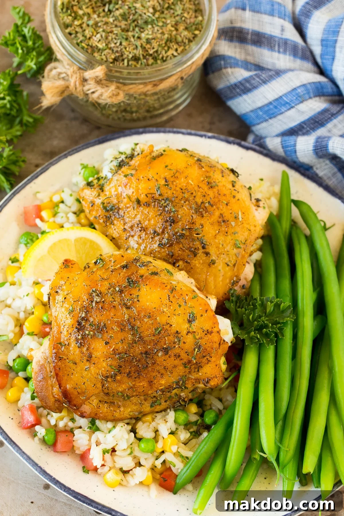 Chicken cooked with Greek seasoning served alongside rice and green beans, showcasing a delicious meal.