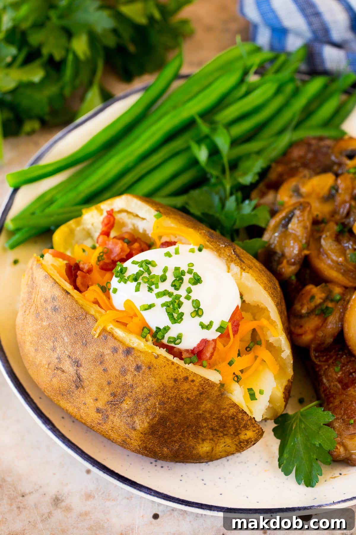 A crock pot baked potato served with steak and green beans.