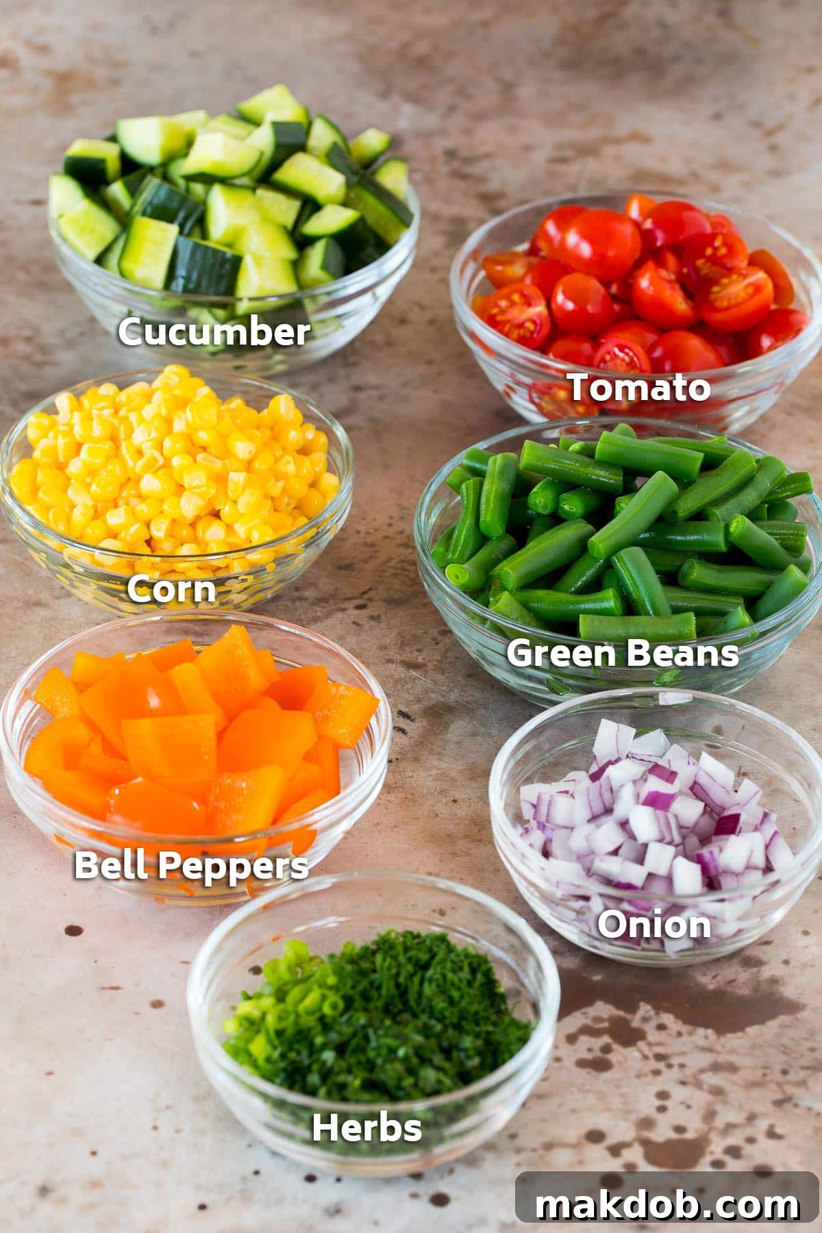 Colorful bowls of fresh vegetables including bright corn, crisp green beans, and ripe tomatoes, ready for a delicious salad.