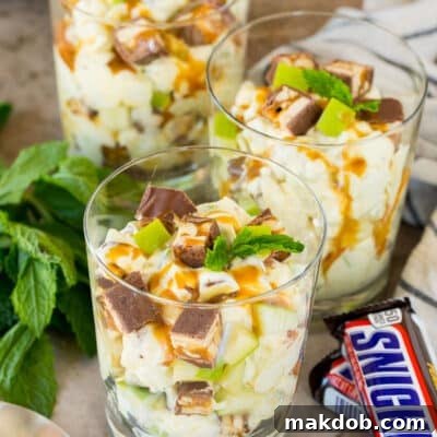 Snickers Apple Delight 7 Individual servings of snicker apple salad garnished with caramel and mint.