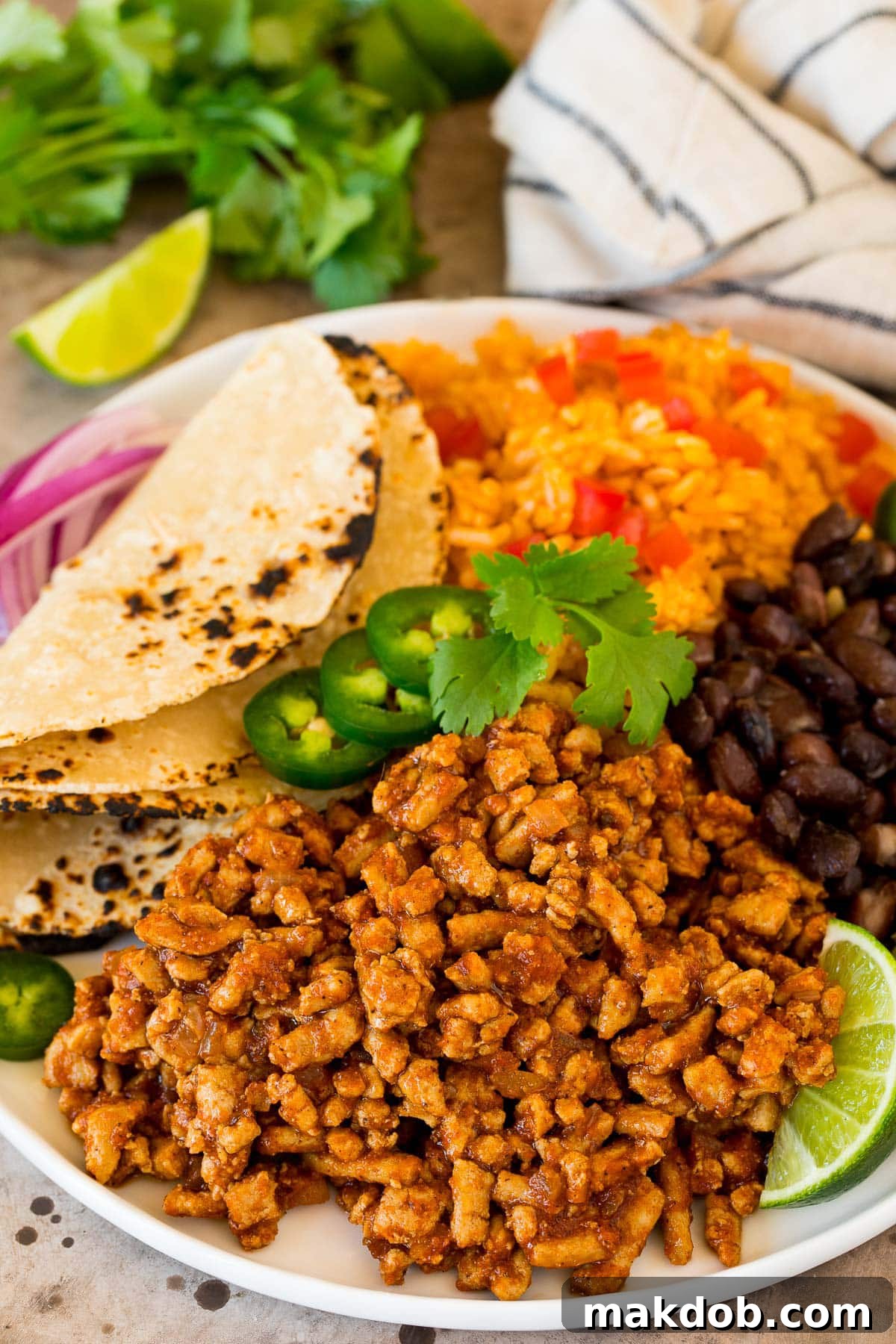 Effortless Turkey Tacos 6 A plate of seasoned ground turkey with rice, beans and tortillas.