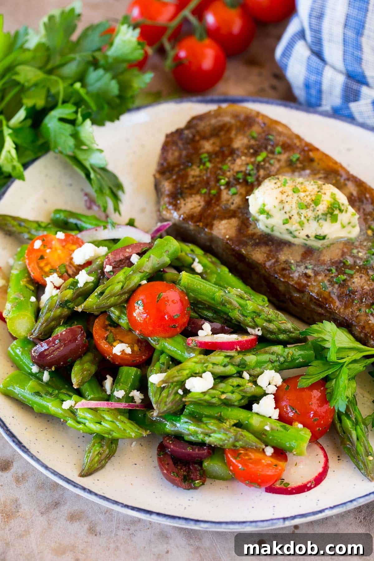 Spring Asparagus Salad 7 Asparagus salad beautifully plated next to a perfectly grilled steak, ideal for a hearty meal.