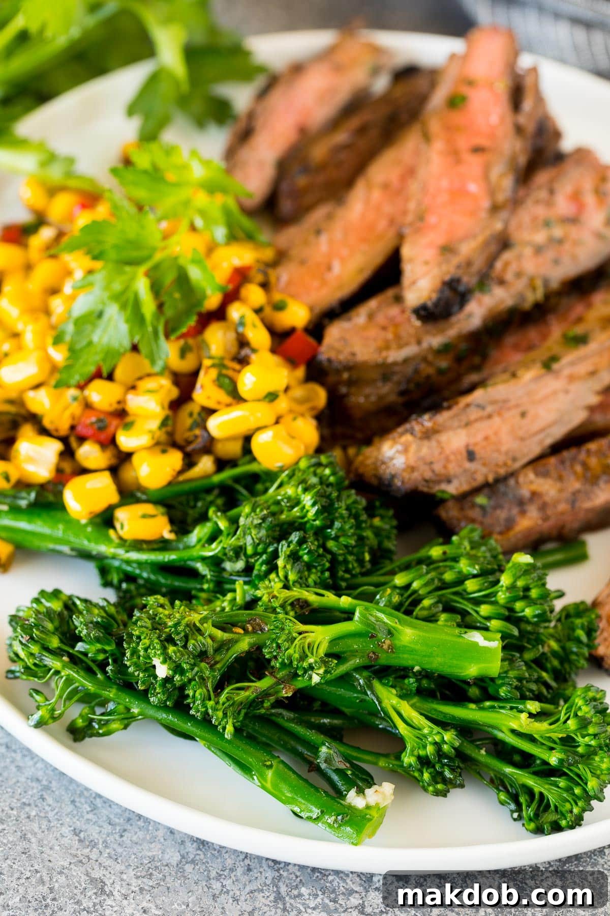 Flavorful Pan-Seared Broccolini 6 Cooked broccolini on a plate with steak and corn, illustrating a perfect meal pairing.