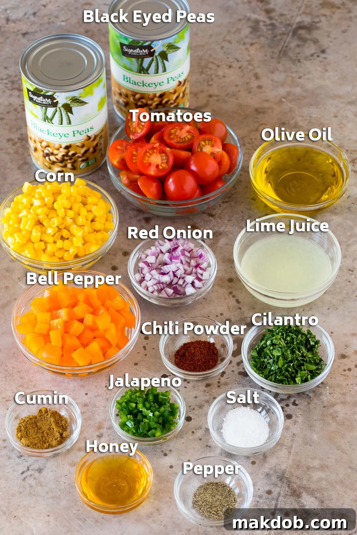 Zesty Black Eyed Pea Salad 3 Individual bowls displaying fresh ingredients for black eyed pea salad, including chopped vegetables, whole peas, olive oil, lime juice, and spices.