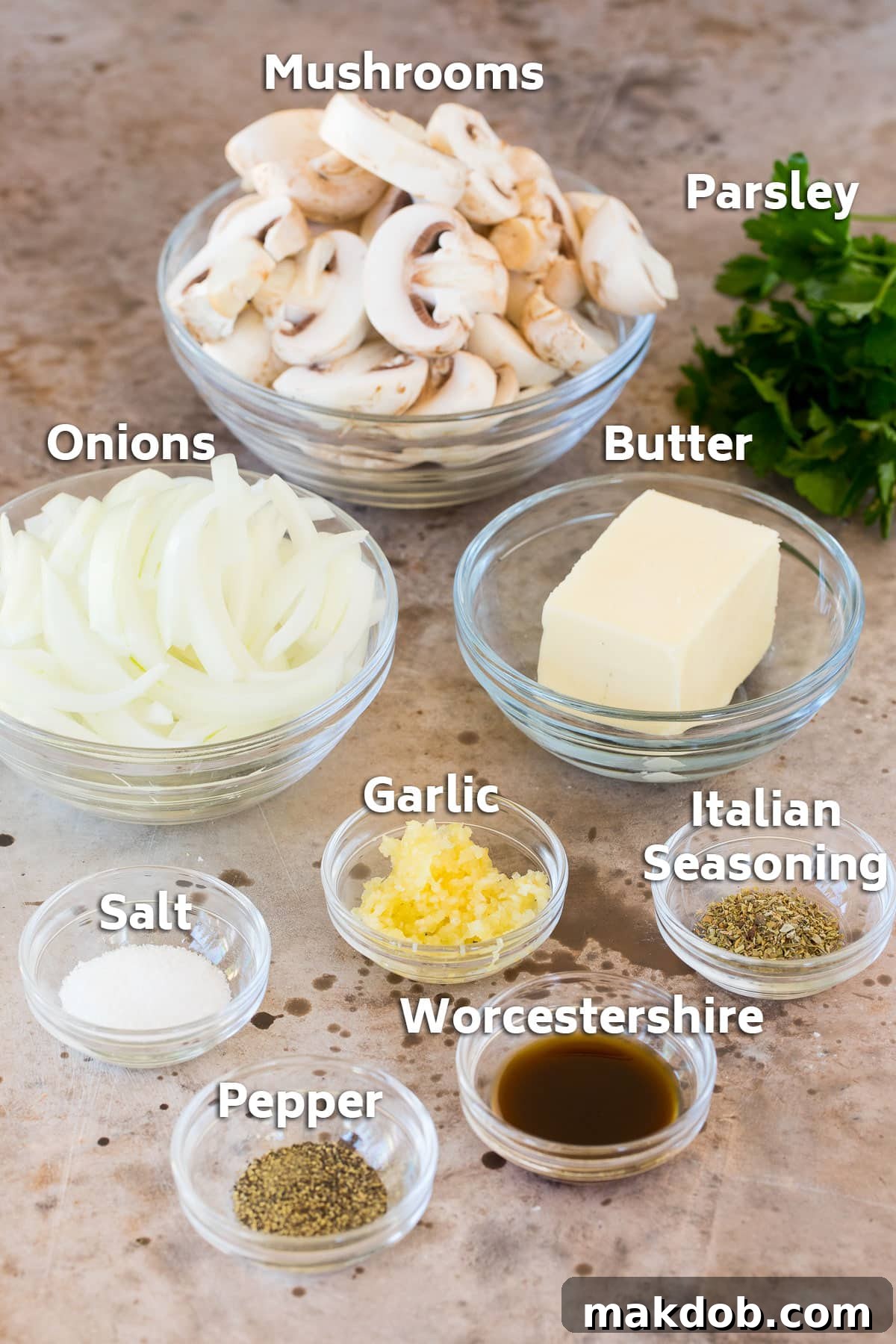 Golden Sauteed Mushrooms and Onions 3 Bowls neatly arranged with fresh mushrooms, sliced onions, a stick of butter, and small bowls of seasonings including garlic and Italian herbs.