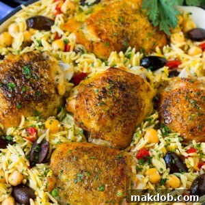 20 Easy One-Pot Chicken Dinners 15 A pan of delicious One Pot Mediterranean Chicken, featuring chicken thighs, orzo, chickpeas, and fresh vegetables.