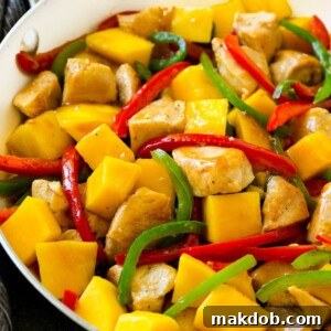 20 Easy One-Pot Chicken Dinners 16 Sweet and savory Mango Chicken in a skillet, bursting with vibrant red and green sliced peppers.