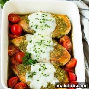 20 Easy One-Pot Chicken Dinners 21 Golden-baked pesto chicken in a baking dish, generously topped with melted cheese and vibrant cherry tomatoes.