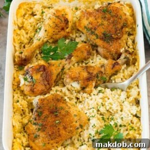A hearty dish of classic chicken and rice casserole, perfectly baked and ready to serve with a serving spoon.