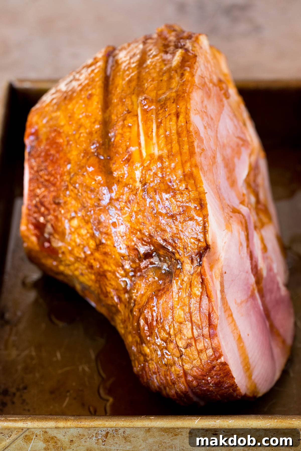 Sweet Glazed Easter Ham 5 A whole ham generously coated in a shimmering brown sugar glaze, ready for the final bake.