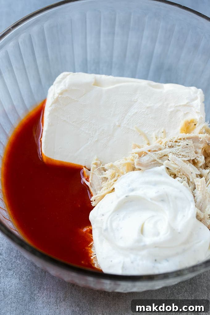 Buffalo Ranch Chicken Dip | Buffalo Chicken Dip | Baked Buffalo Dip | Cheesy Buffalo Dip #buffalowings #buffalochicken #dip #lowcarb #appetizer #dinneratthezoo Ingredients for the dip in a bowl.