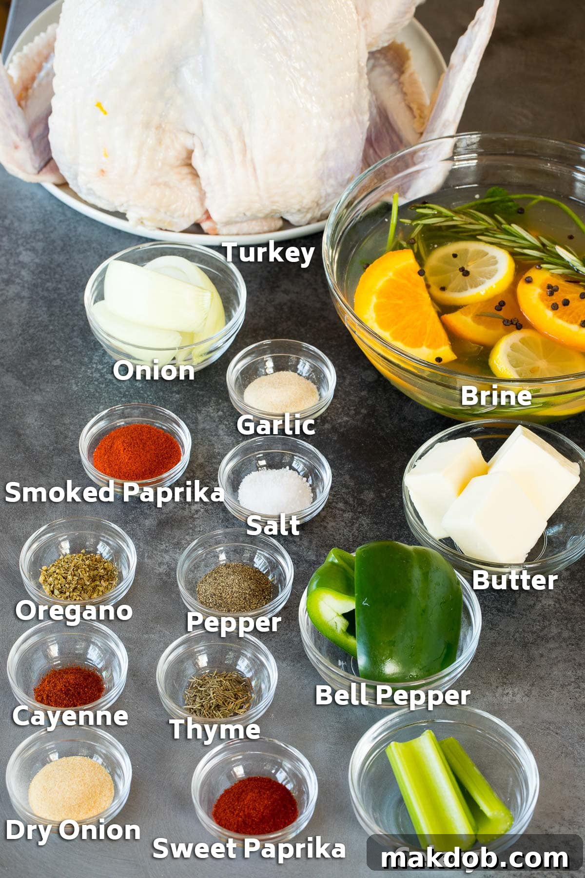 Spicy Cajun Turkey Feast 3 Ingredients including a turkey, brine liquid in a bowl, small bowls of various seasonings, and whole vegetables laid out on a table.