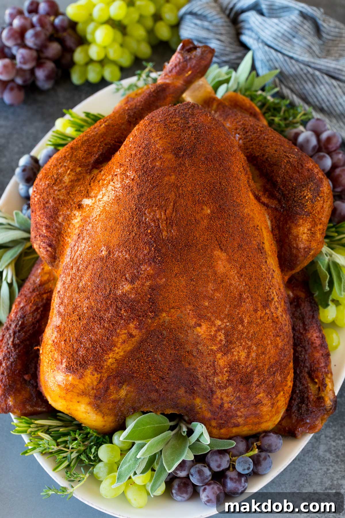 A cooked smoked turkey on a serving platter.
