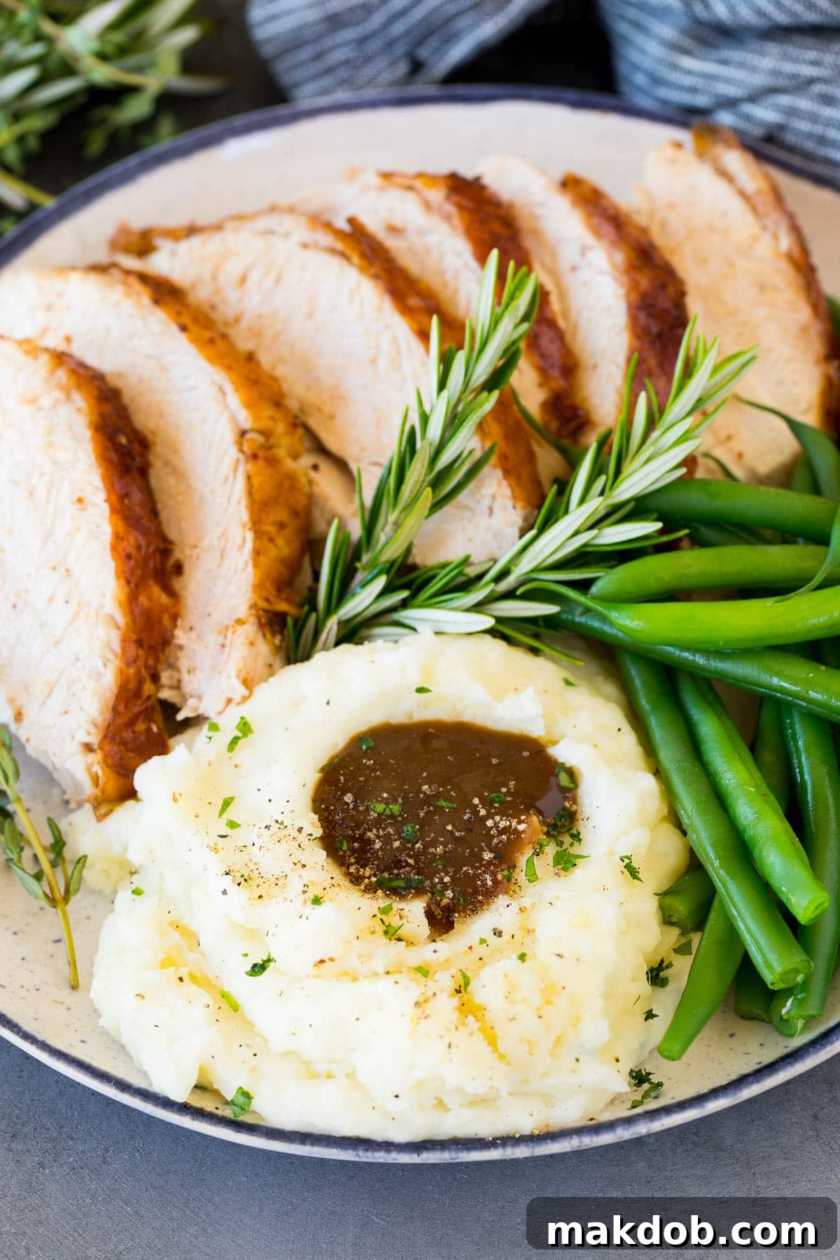 Velvety Sour Cream Mash 6 Sour cream mashed potatoes on a plate with turkey and green beans.