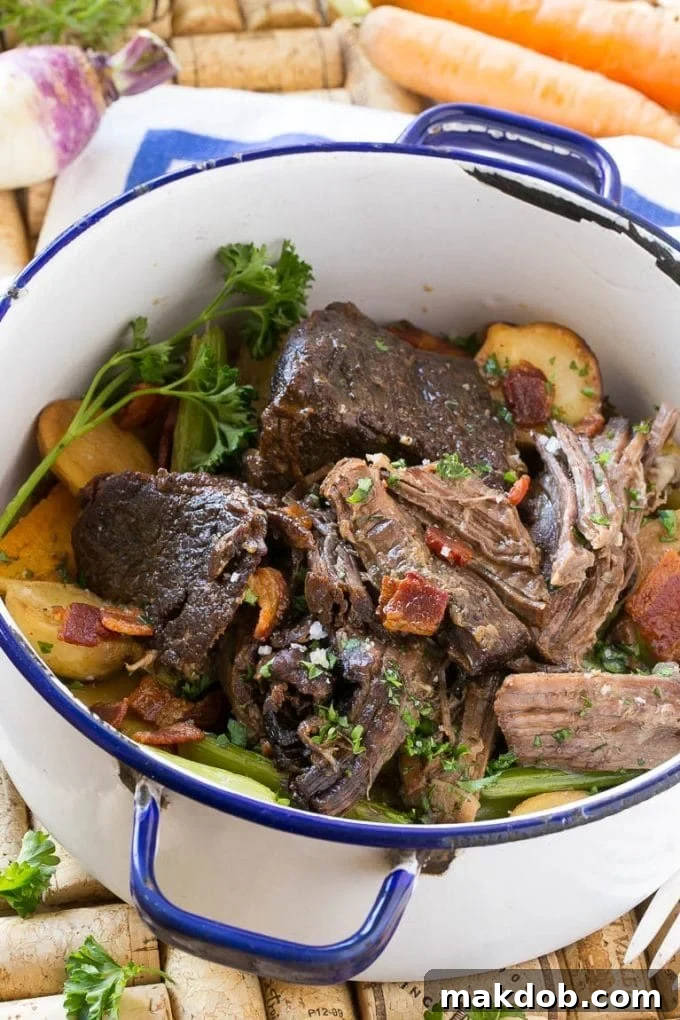 A delicious Yankee pot roast, rich with bacon, tender potatoes, and wholesome root vegetables, ready to be served.