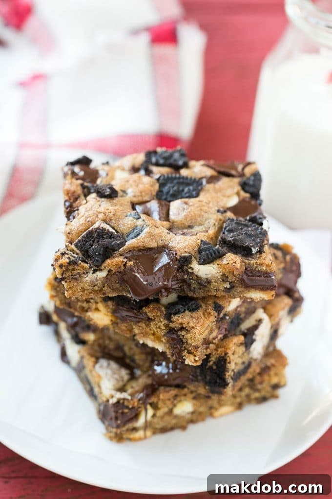 A beautifully arranged serving plate showcasing rich Oreo cookies and cream blondies, cut into perfect squares.