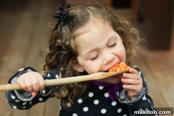 Pinto Beans and Rice Recipe | Mexican Rice Recipe | Pinto Beans Recipe #beans #rice #mexicanfood #glutenfree #dinner #dinneratthezoo A child happily enjoying a spoonful of delicious homemade Mexican rice.