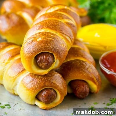 Bagel dogs served with ketchup and mustard on the side.