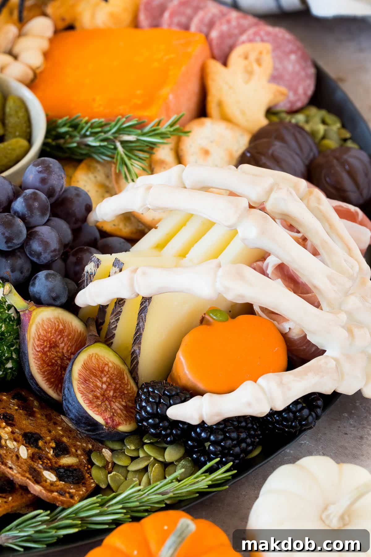 Assorted fruits and cheeses beautifully arranged on a party platter, ready for guests.