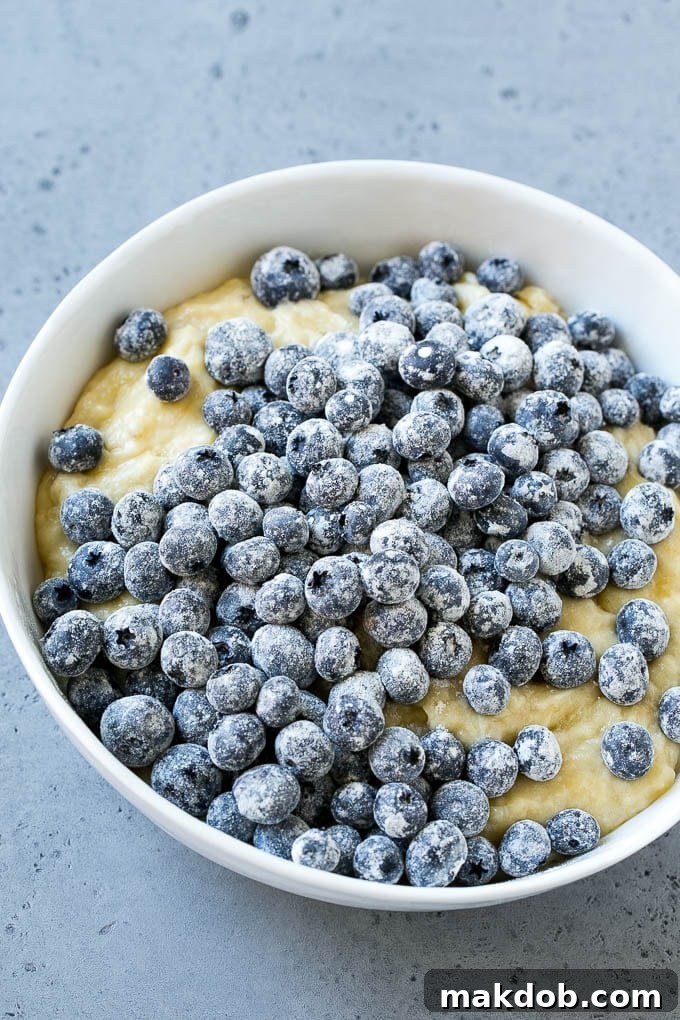 Blueberry Banana Bread | Easy Banana Bread | Homemade Banana Bread Recipe A bowl of banana bread batter with fresh blueberries on top.