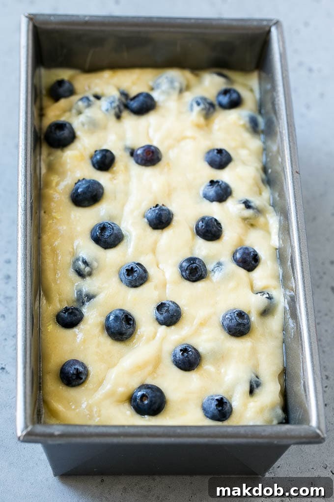 Blueberry Banana Bread | Easy Banana Bread | Homemade Banana Bread Recipe Blueberry banana bread batter in a loaf pan.