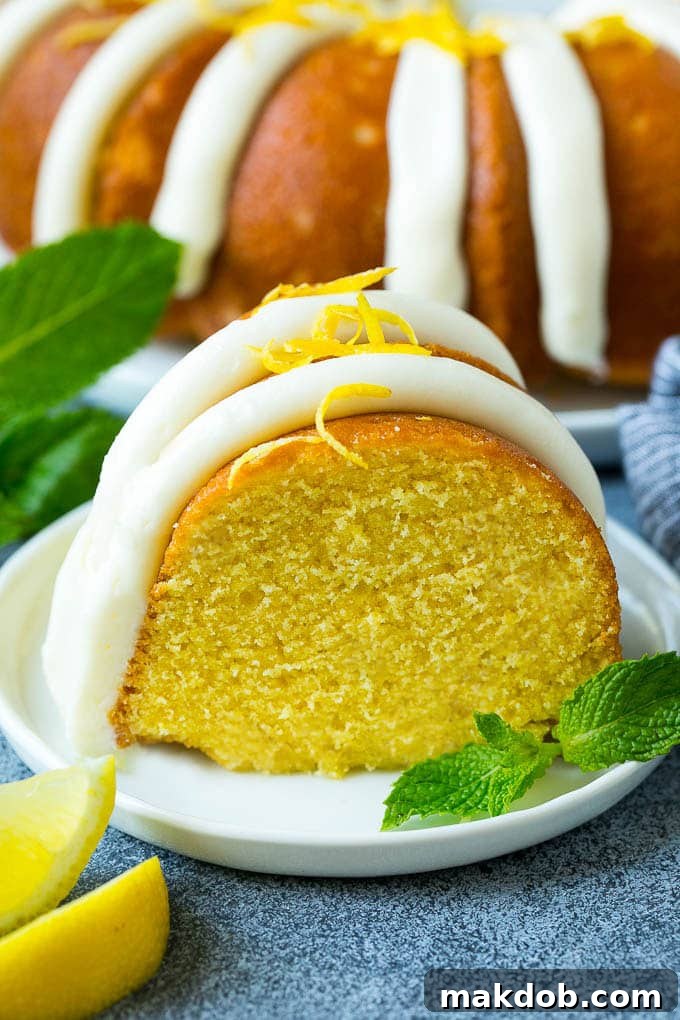 A perfect slice of lemon bundt cake, beautifully frosted and ready to be enjoyed as a refreshing dessert.