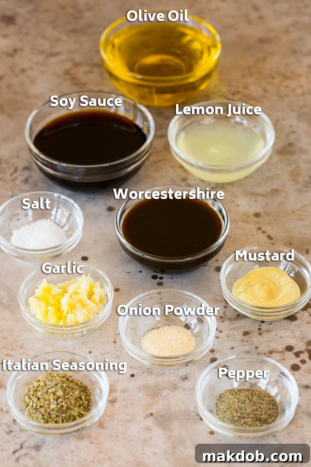 Next-Level Skirt Steak Marinade 3 Bowls of fresh ingredients for skirt steak marinade, including olive oil, soy sauce, lemon juice, Worcestershire sauce, minced garlic, Dijon mustard, Italian seasoning, salt, pepper, and onion powder.