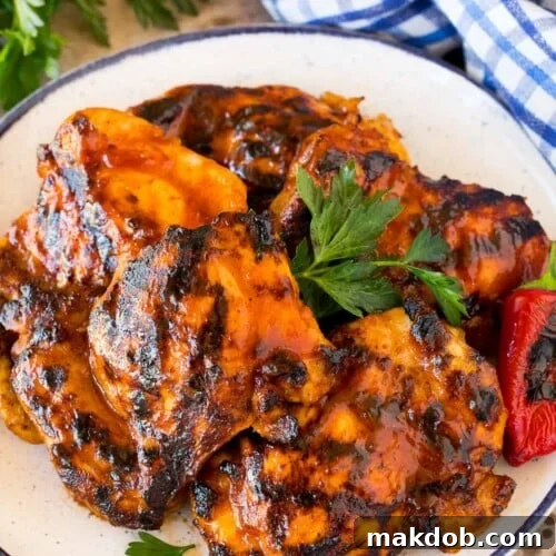 BBQ chicken marinade on chicken thighs that have been grilled and are on a platter.