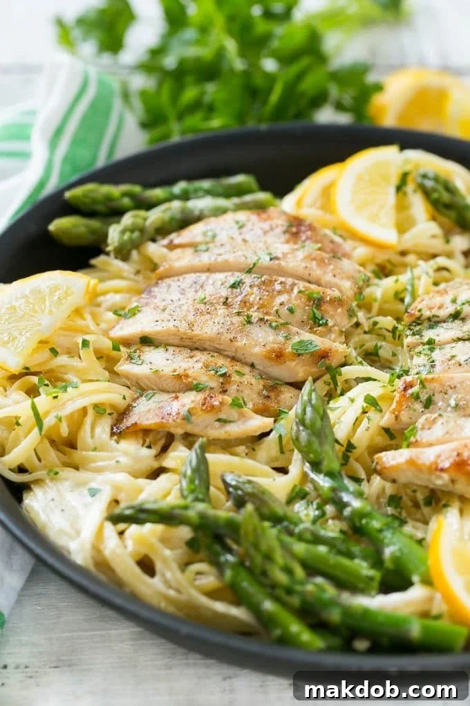 Close-up of Lemon Asparagus Pasta with Grilled Chicken in a Skillet A skillet filled with creamy lemon asparagus pasta and perfectly sliced grilled chicken, ready to be served.