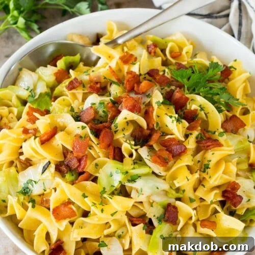 A bowl of haluski topped with bacon and parsley, a delicious comfort food recipe.