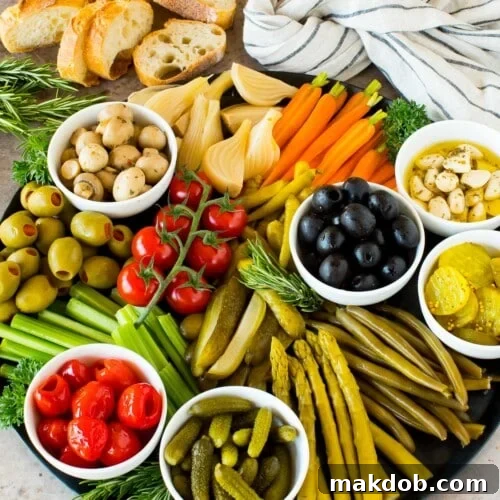 A relish tray filled with pickles, fresh vegetables and marinated veggies.