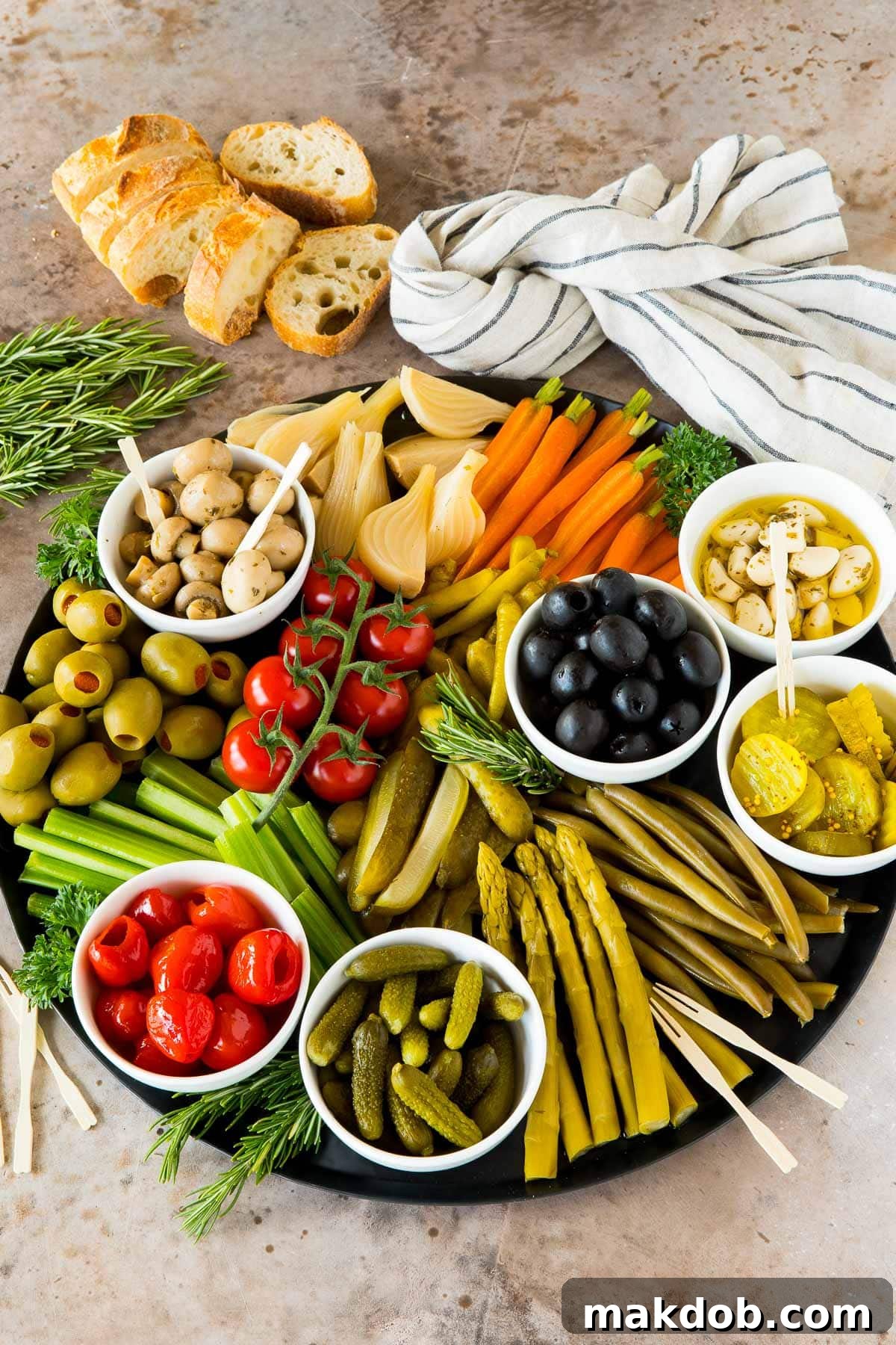 A beautifully arranged relish platter showcasing a diverse collection of different types of vegetables and briny olives, ready for serving.