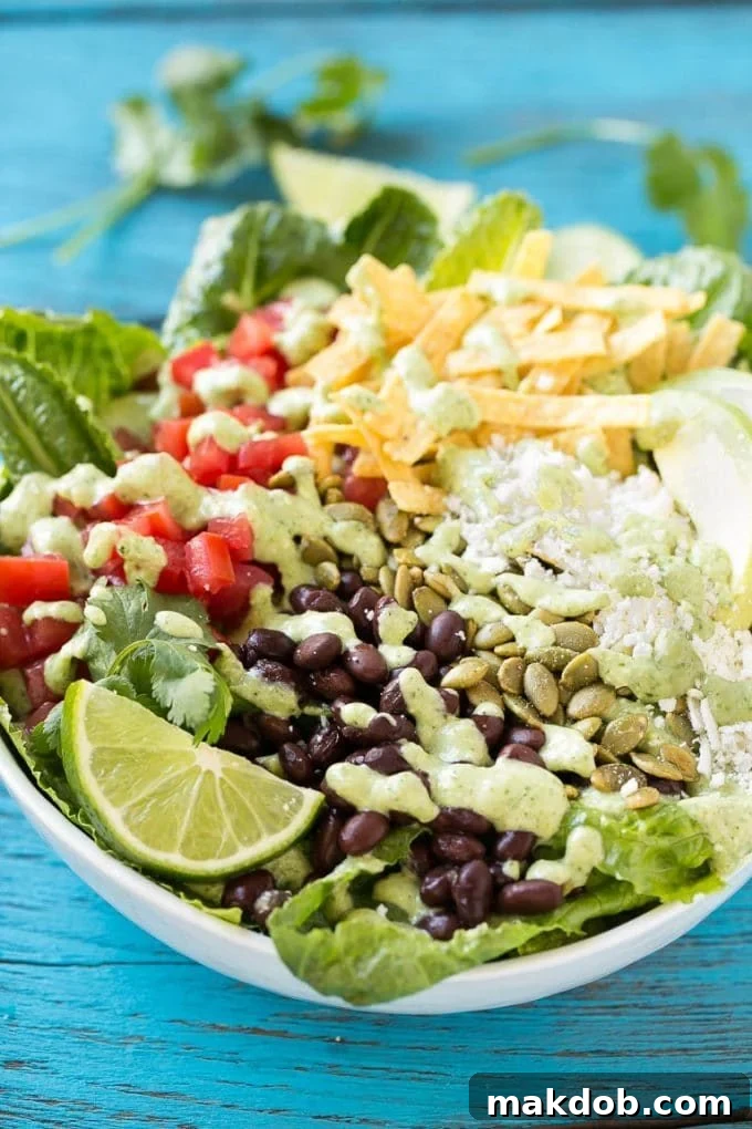 Mexican Caesar Salad Recipe | Caesar Salad | Mexican Salad #salad #beans #lunch #dinner #dinneratthezoo Creamy cilantro dressing drizzled over a bowl of Mexican Caesar salad.