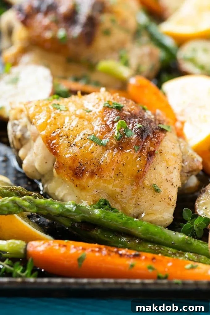 A tantalizing sheet pan meal featuring lemon thyme chicken, roasted potatoes, and fresh asparagus, ready for serving.